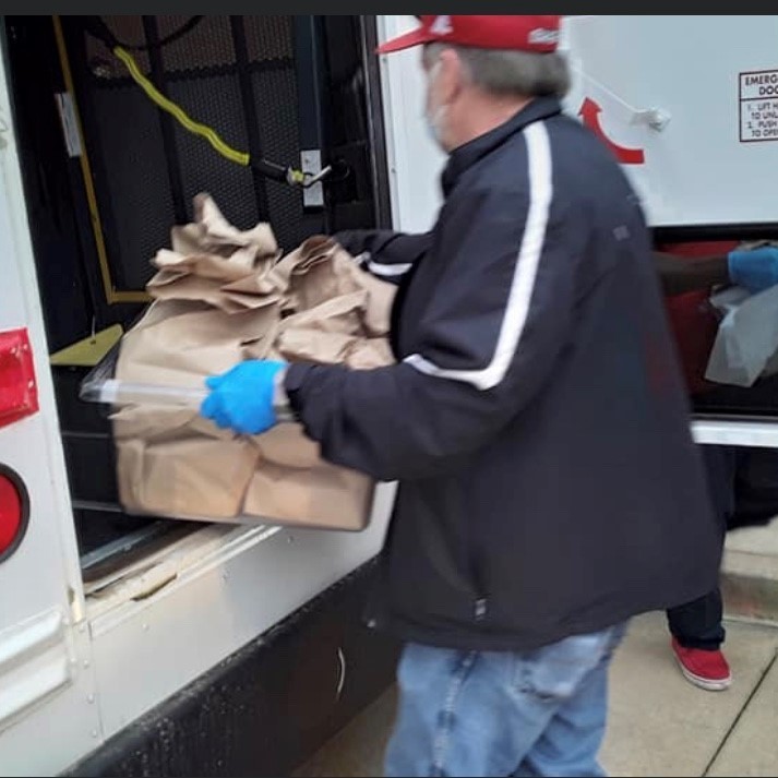 Staff Loading Buses for Food Drop Off