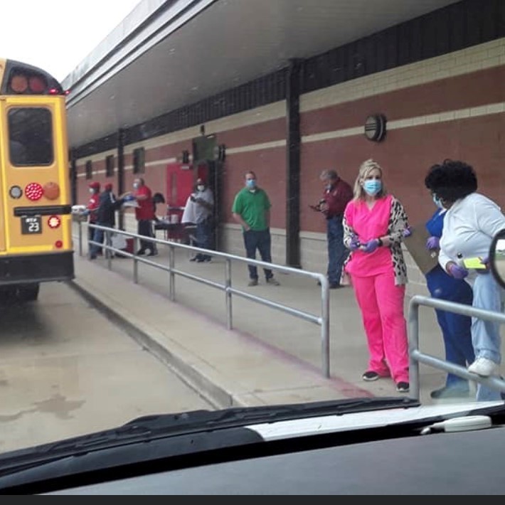 Staff Loading Buses for Food Drop Off