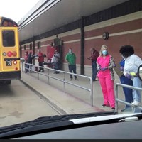 Staff Loading Buses for Food Drop Off