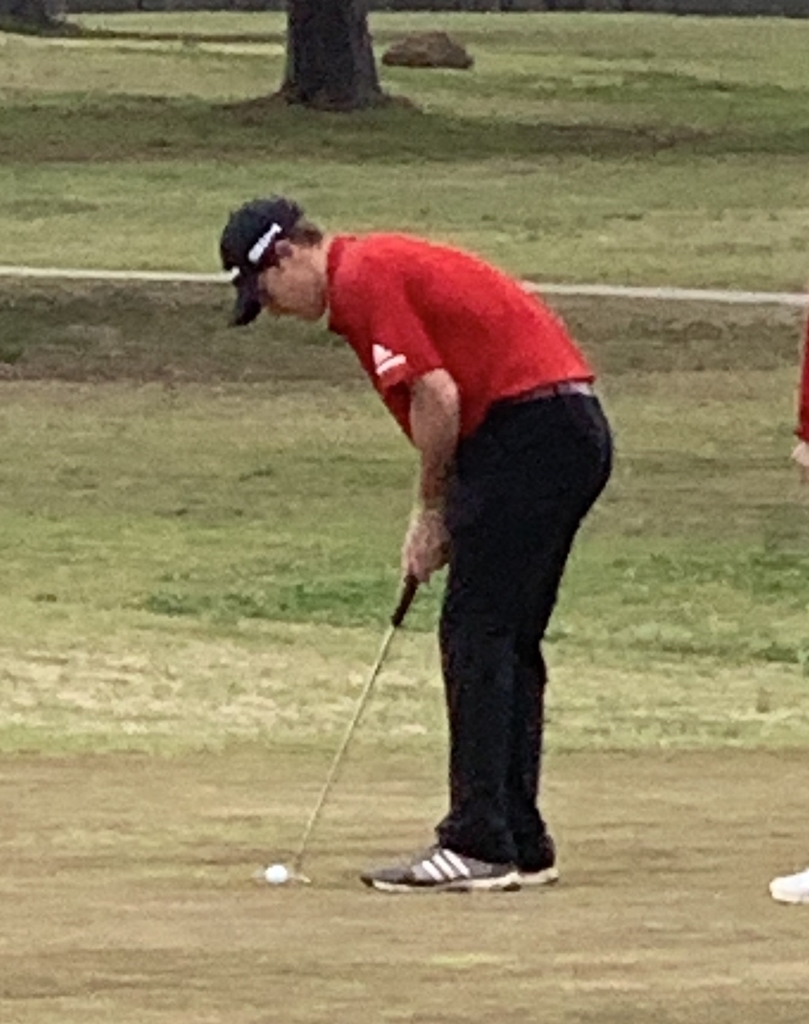 Student golfer making a putt